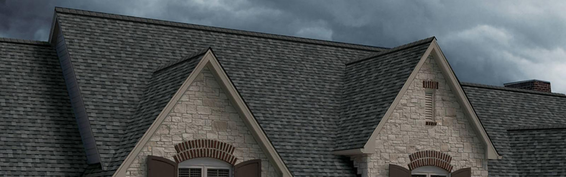 Home with a dark gray shingle roof